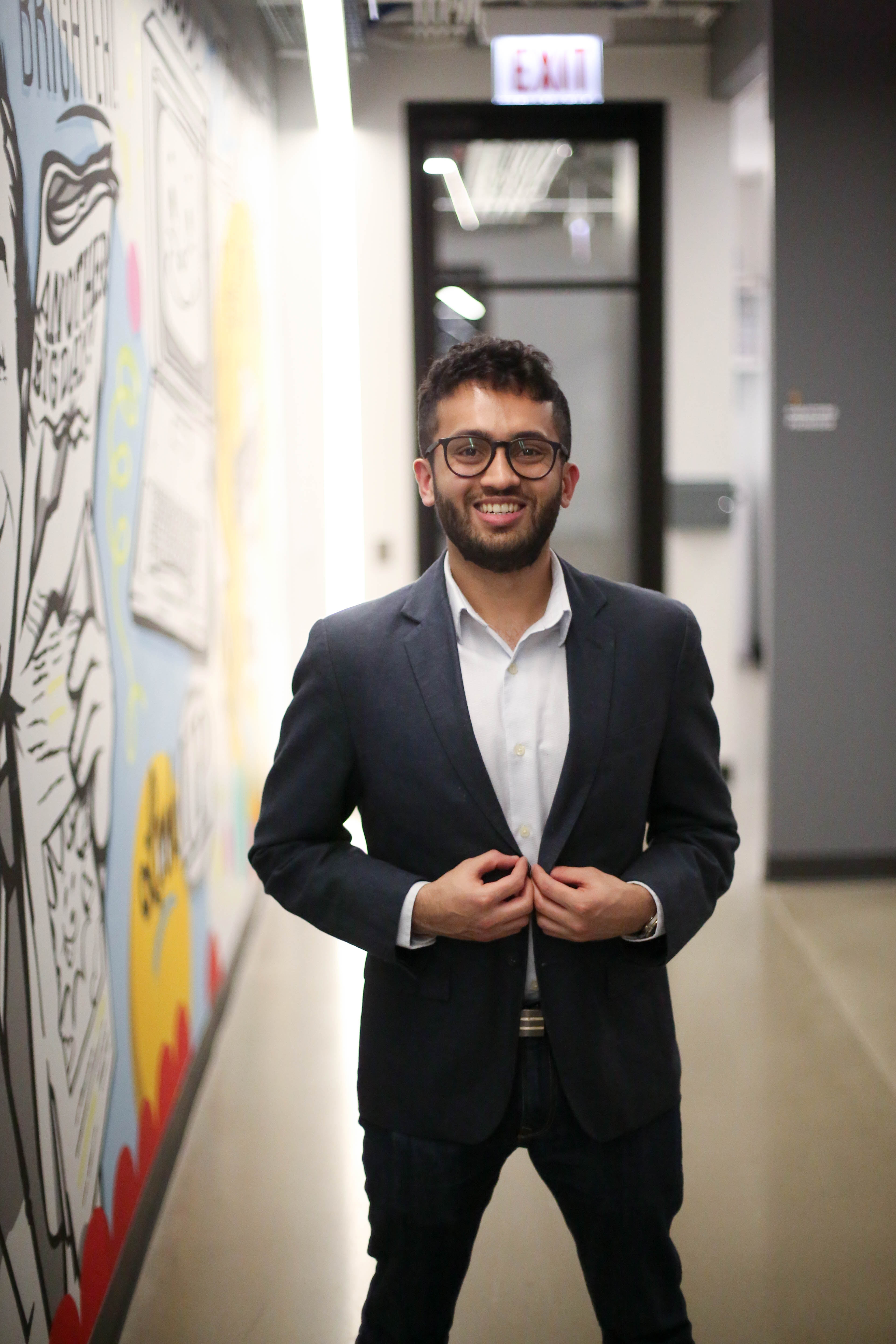 A headshot of Hardik Sodhani, who is smiling while wearing a blazer over a white shirt.